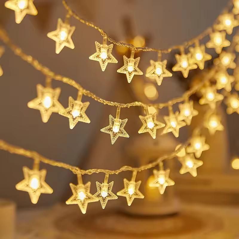 String of star-shaped lights with a warm glow on a blurred background
